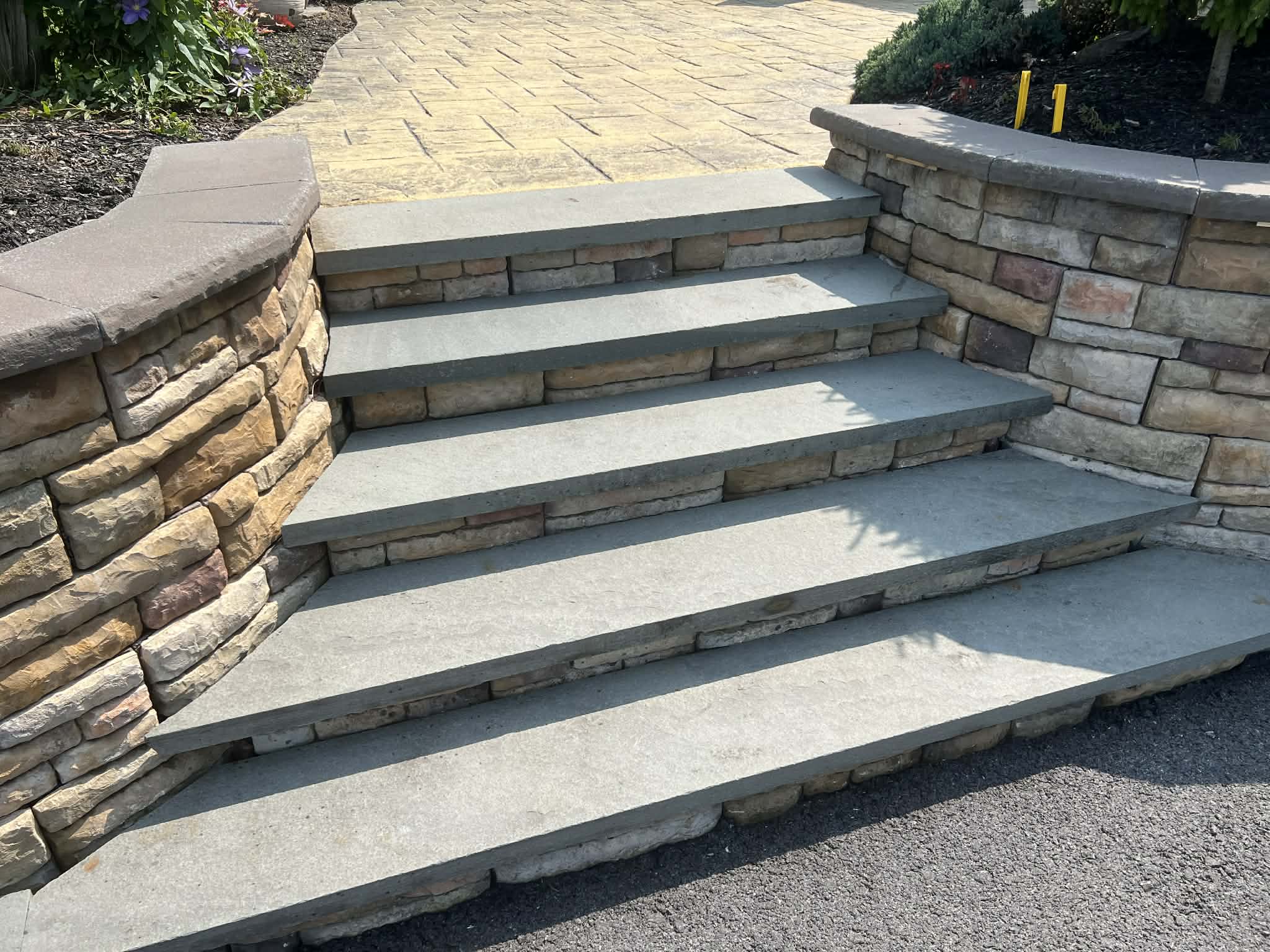 Stone steps and masonry wall after pressure washing — clean stone treads and bright mortar joints